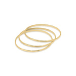 Set of three elegant gold bangles from ARIIRA, perfect for stacking or wearing individually.