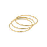 Set of three elegant gold bangles from ARIIRA, perfect for stacking or wearing individually.