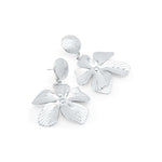 Malia Bloom statement earrings by ARIIRA, featuring silver petals with delicate textures for a bold yet lightweight look.
